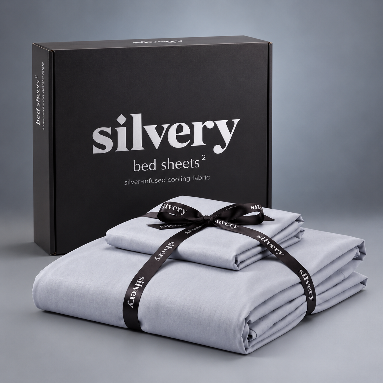 Silvery® Bed Sheets 2.0 box beside the silver-grey sheet set tied with a Silvery ribbon