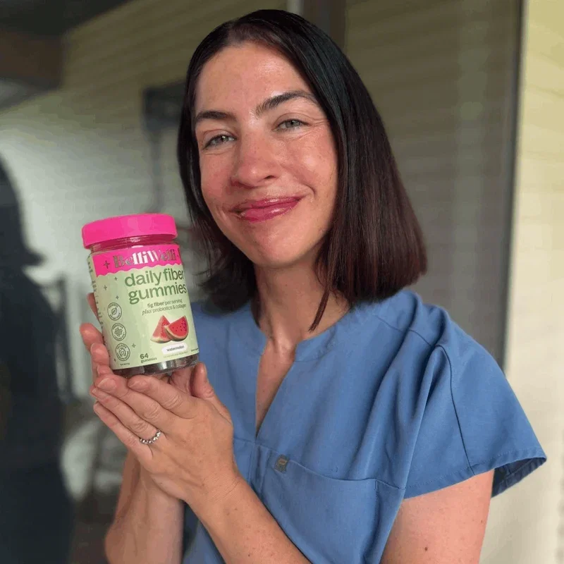 Dr. Jennah Siwak smiling and holding up a jar of BelliWelli Watermelon daily fiber gummies