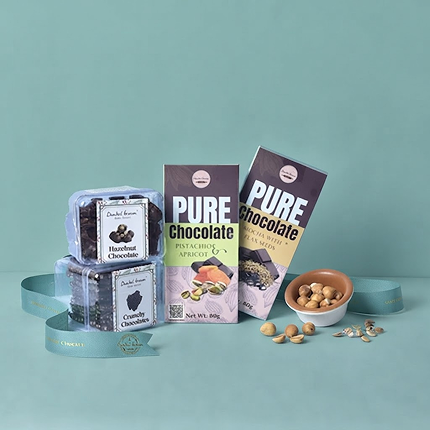 Dunkel Braun chocolate products arranged with bakery treats and a green gift ribbon