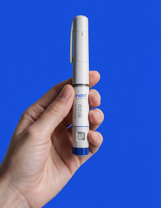 The MORE Research RETA 30 pen, white with a blue cap, held in a hand