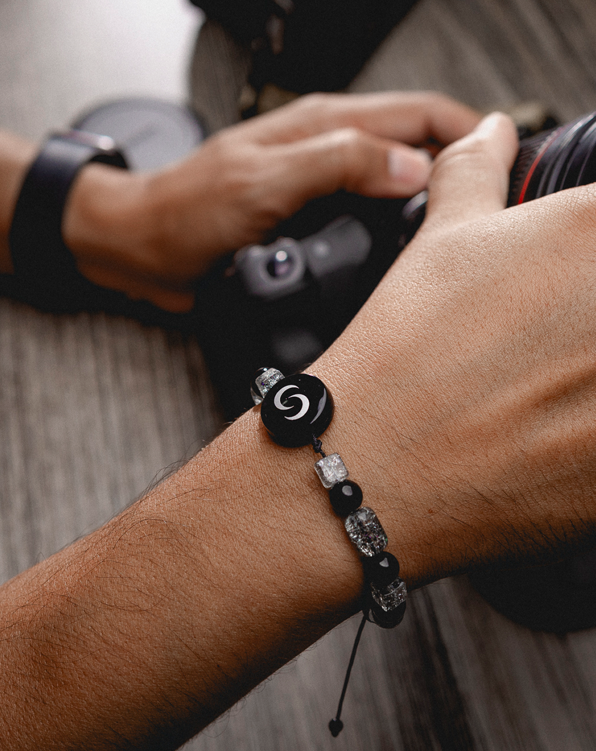 Contact Co. Link Bracelet worn on the wrist while holding a camera