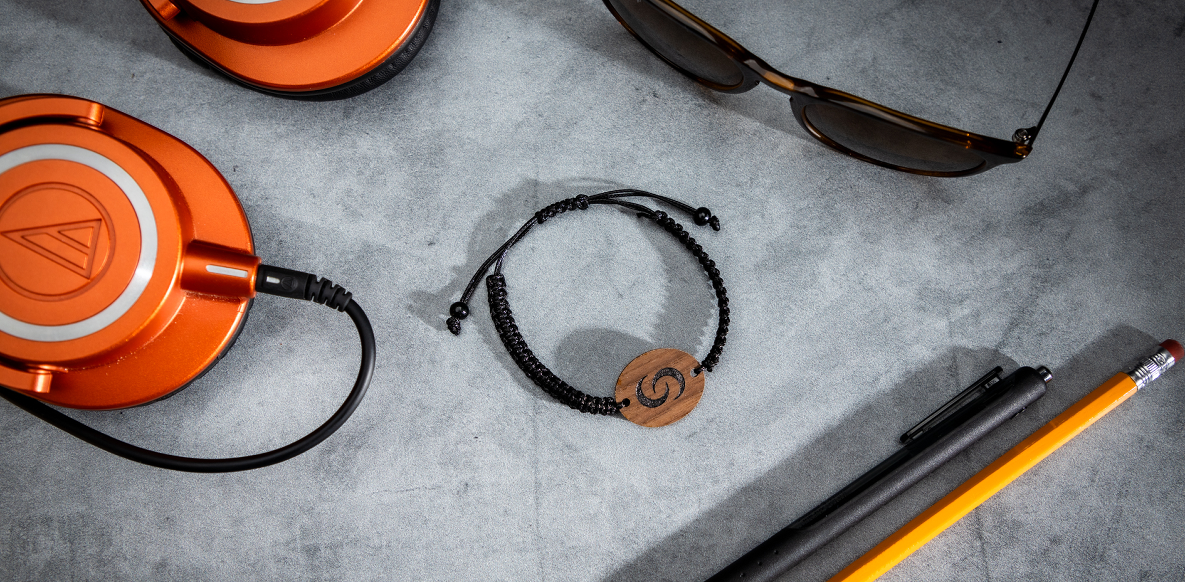 Smart Wooden Bracelet flat lay with headphones and sunglasses