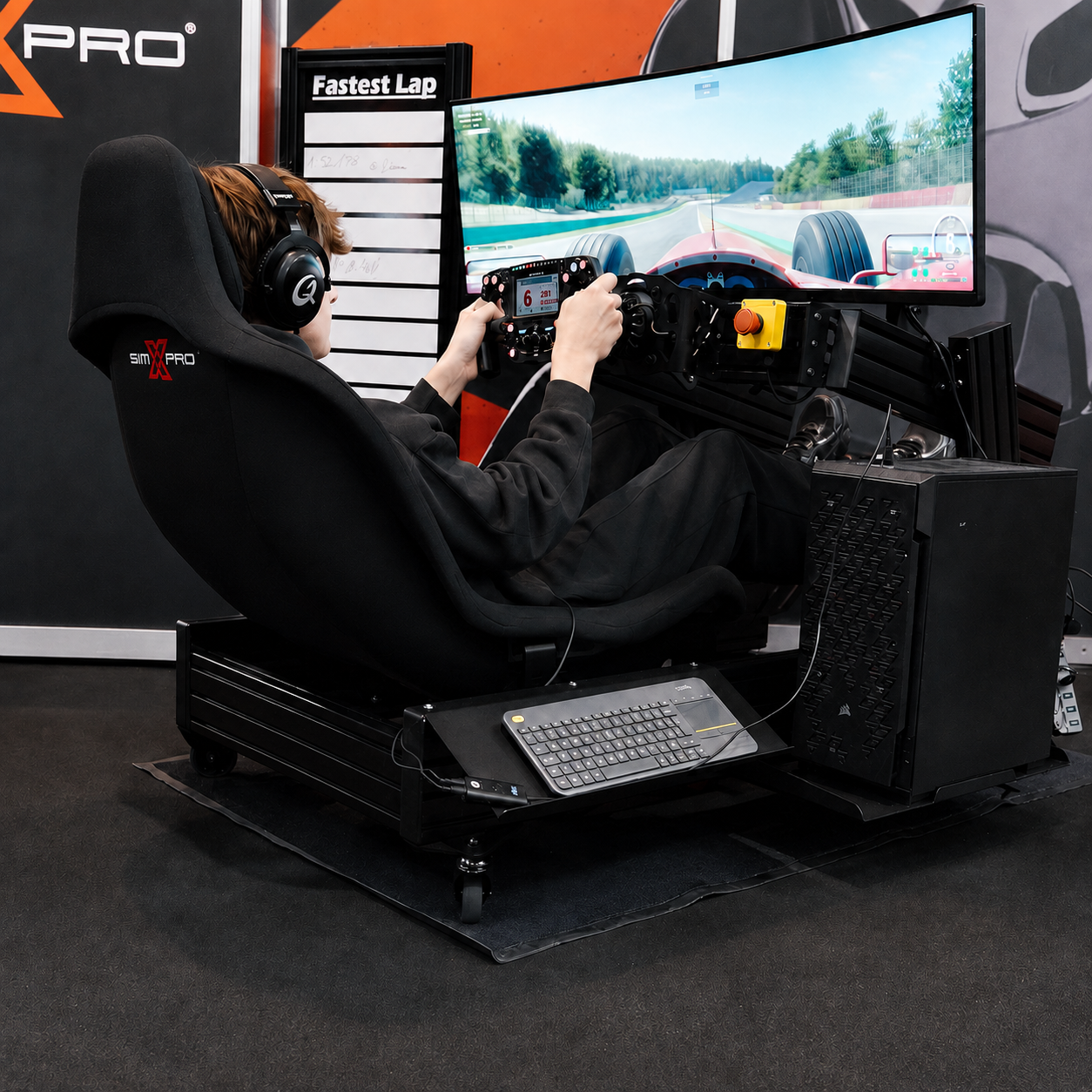 Sim racer in a SimXPro cockpit with a curved monitor and racing wheel
