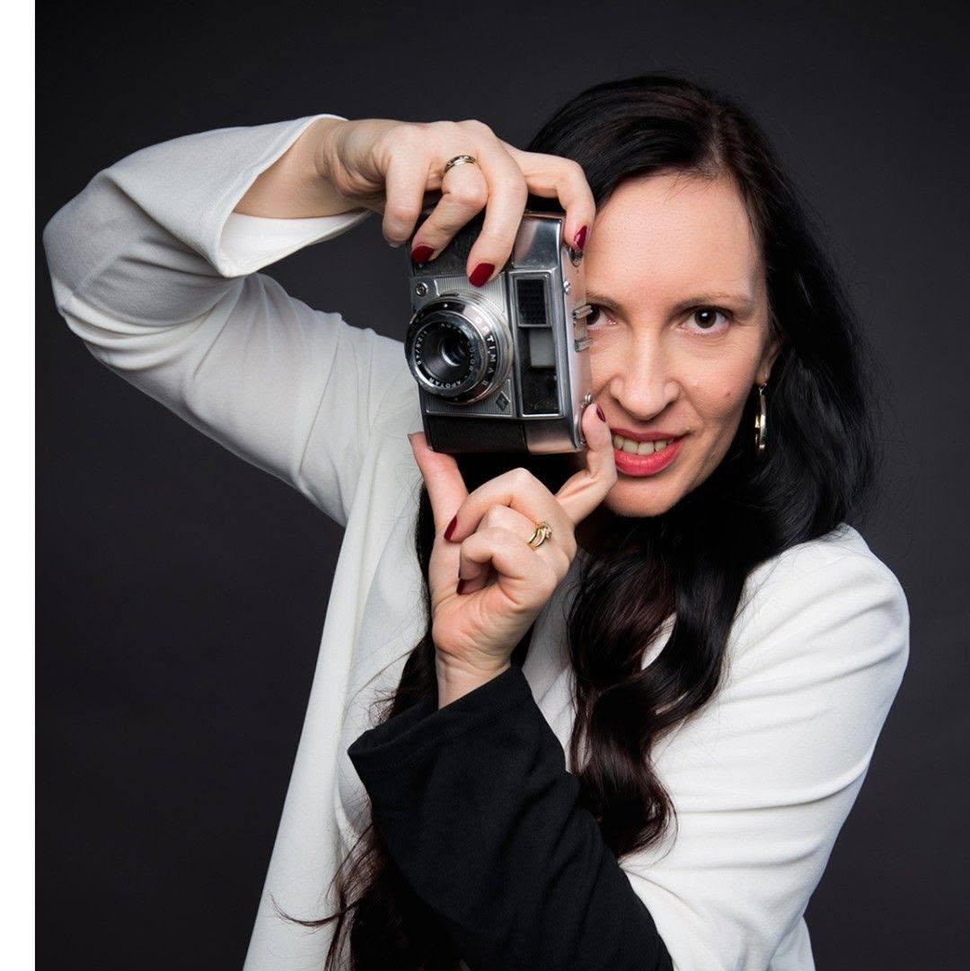 Branka, photographer for Anisence and Rin's mum, holding a vintage camera
