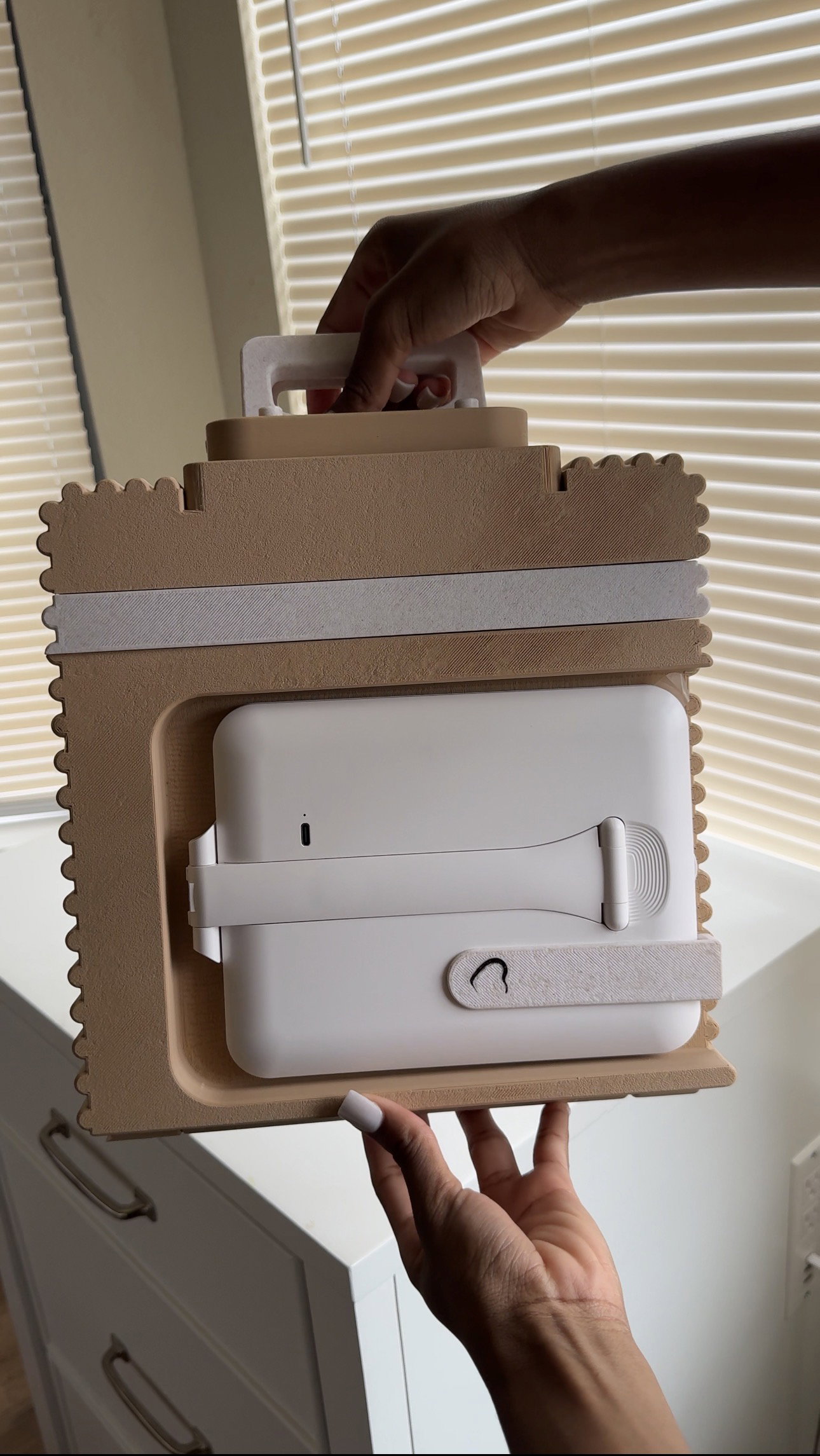 Folded tan Lap Vanity carried by its built-in handle, mirror stowed flat inside the scalloped shell