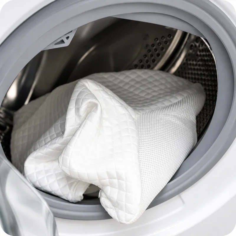 White quilted pillow cover inside the drum of a washing machine