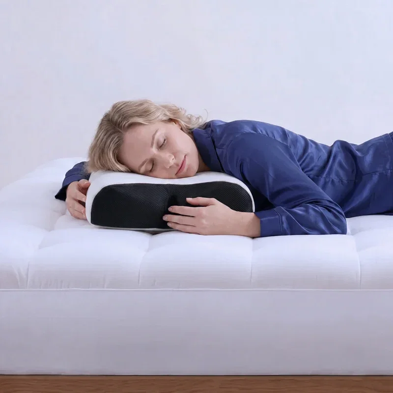 Woman sleeping peacefully on her stomach, resting her head on the Multi-Position Pillow