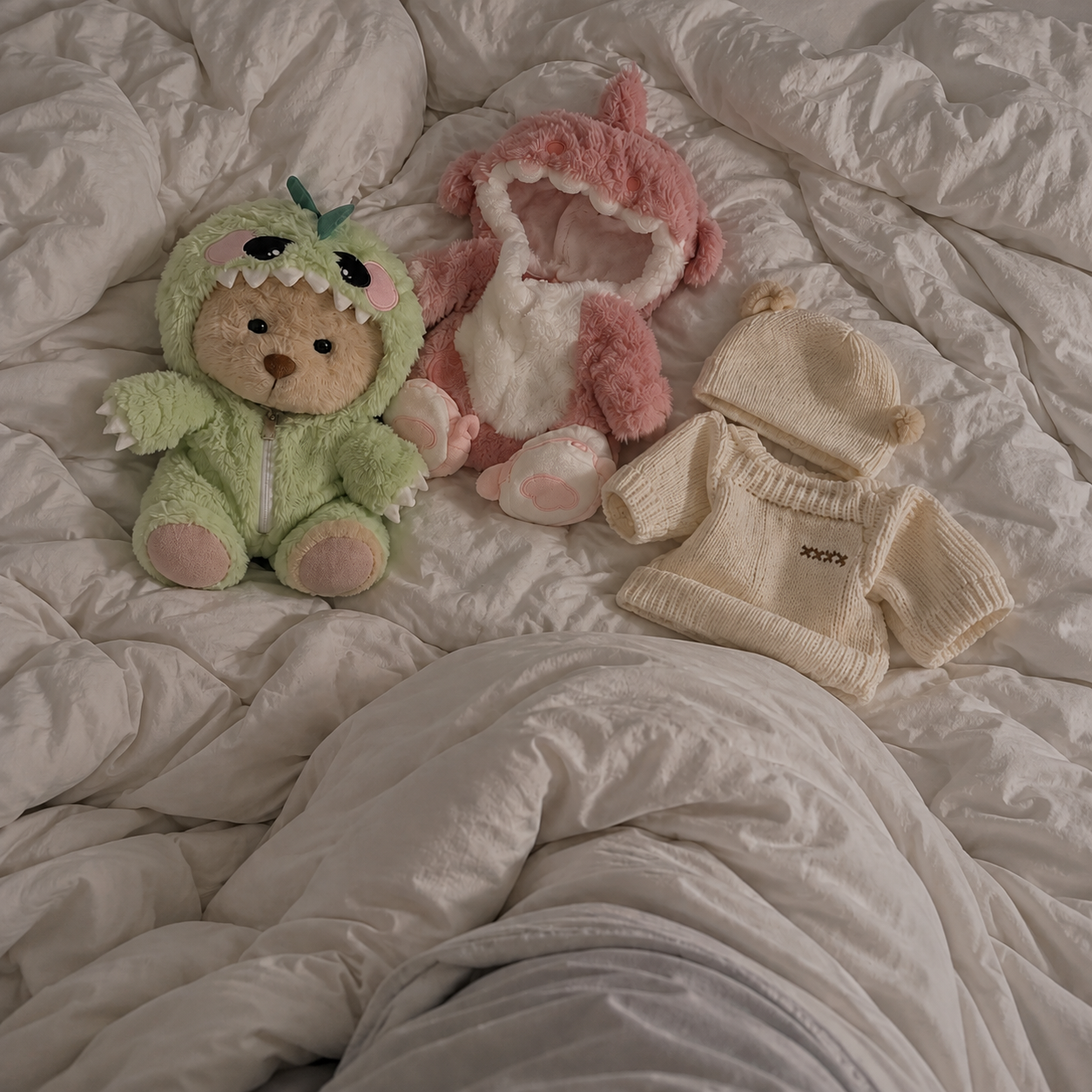 Sophie hugging her teddy bear in the elephant jumpsuit