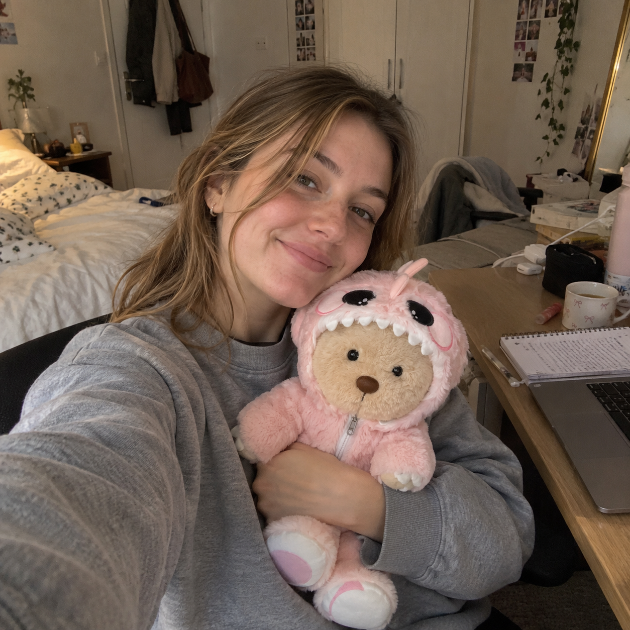Emma holding her teddy bear next to her face