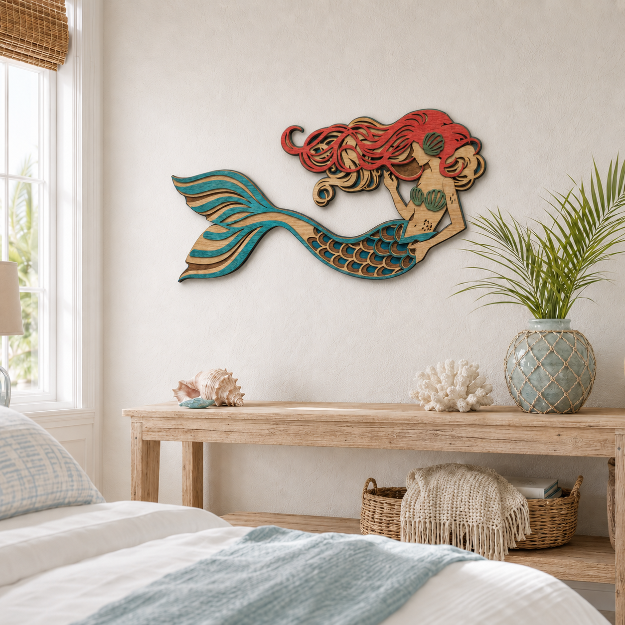 Wooden mermaid wall art above a wooden console table with coral and plant in a cozy bedroom