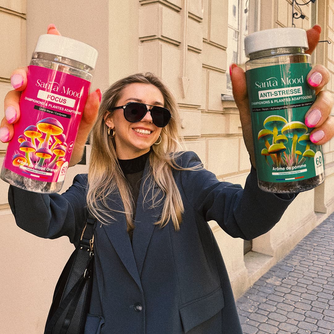 Smiling woman in sunglasses holds two Santa Mood's jars labeled &quot;Focus&quot; and &quot;Anti-Stress&quot;.