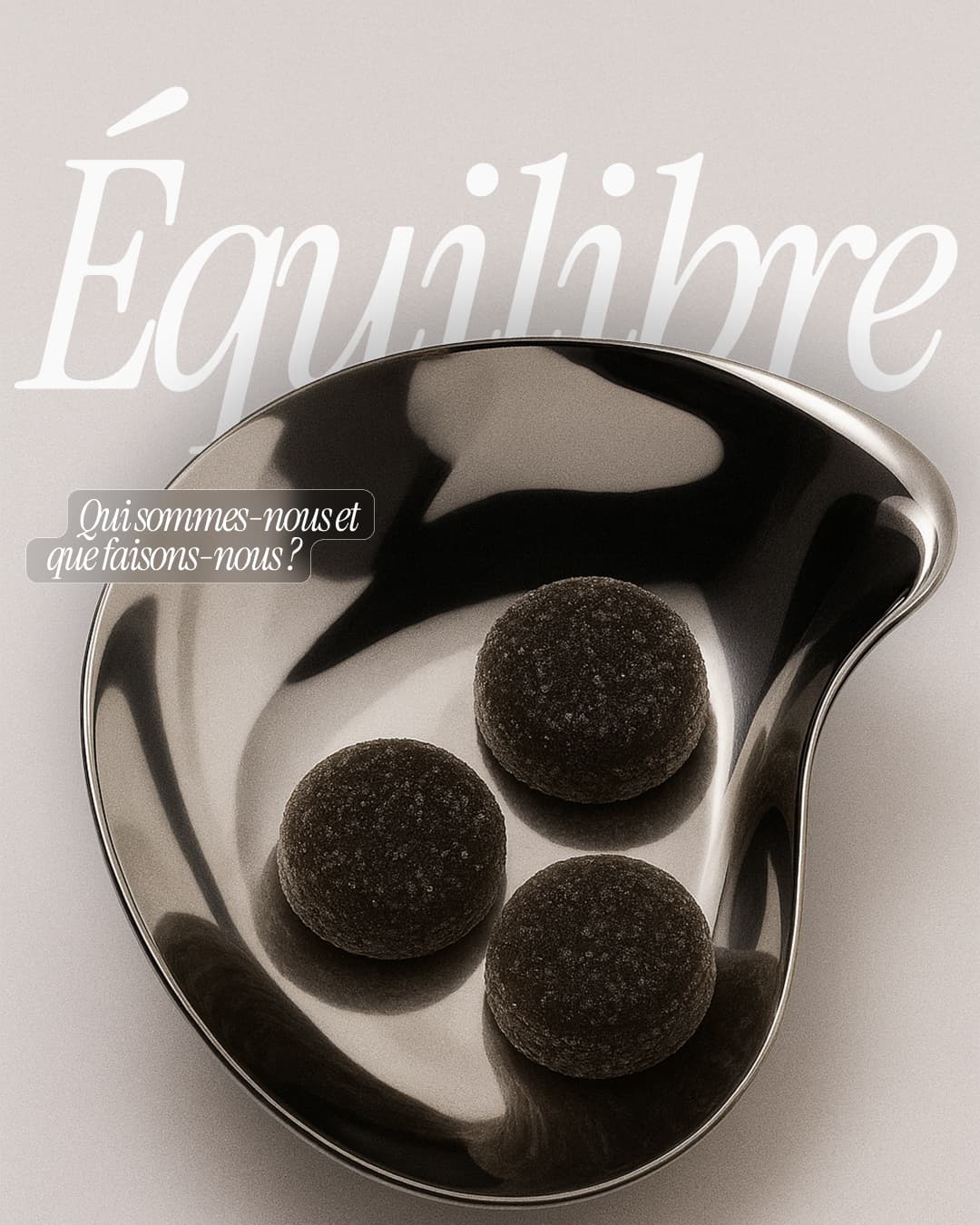Three black round gummies in a shiny silver dish with &quot;Équilibre&quot; text above.