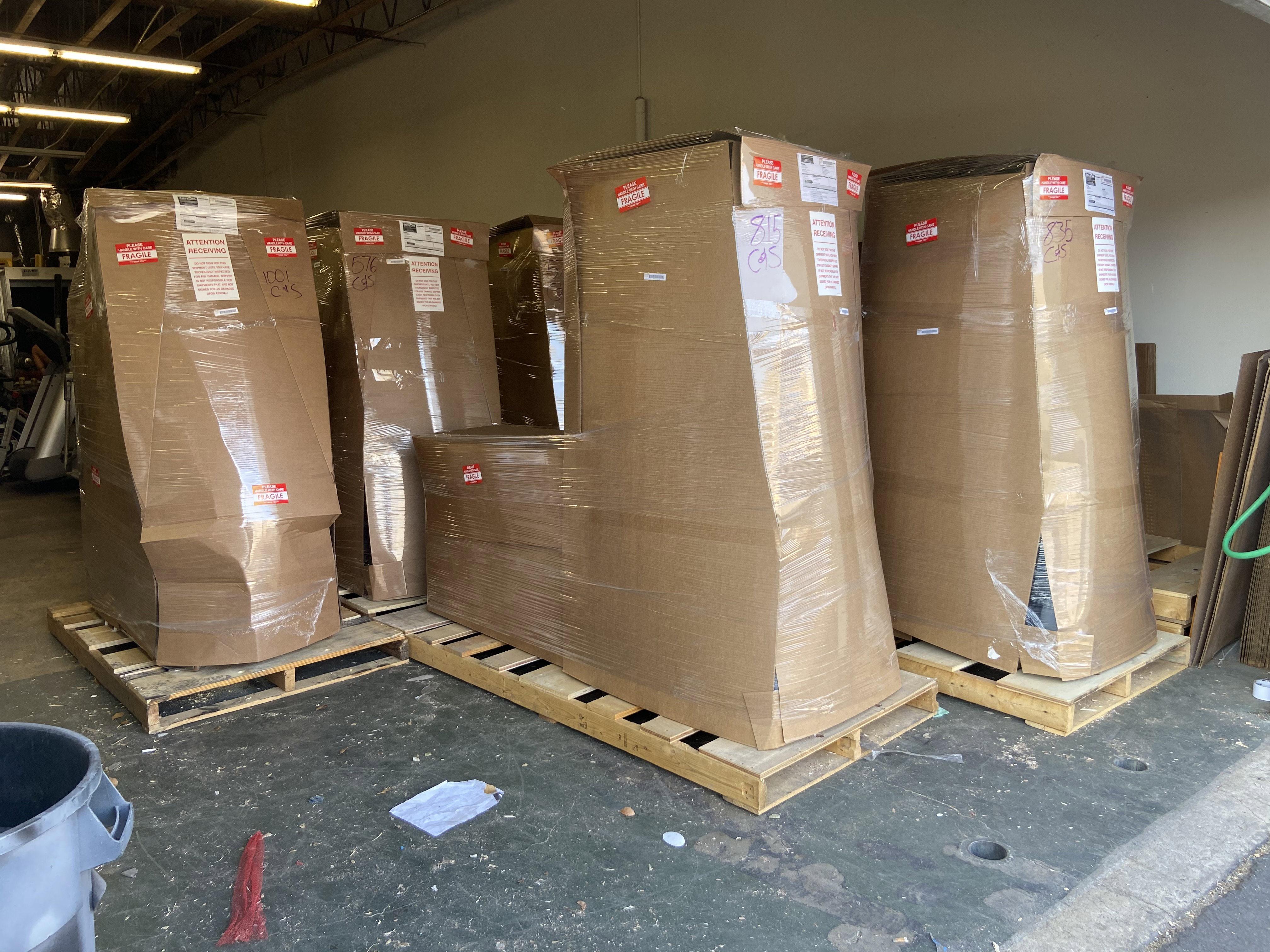 Commercial fitness equipment wrapped and palletized for freight shipping