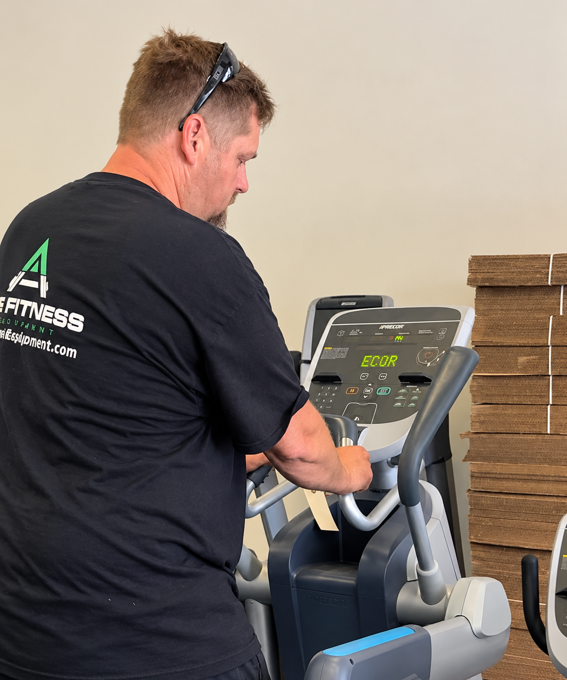 Technician inspecting a commercial treadmill
