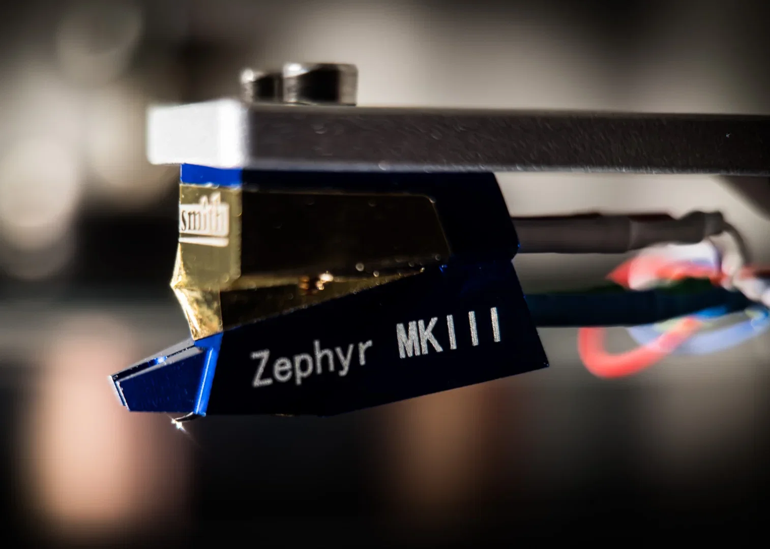 Close-up of a cartridge and stylus tracking the grooves of a record