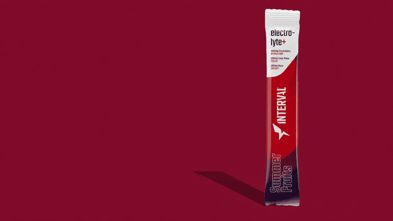 Single red and purple packet labeled 'electrolyte+', 'INTERVAL', and 'Summer Fruits' on a red background