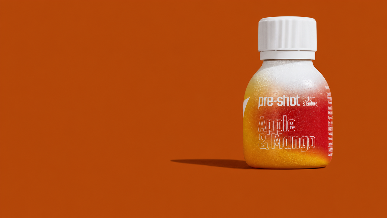 Small bottle of pre-shot apple and mango flavored performance and endurance drink