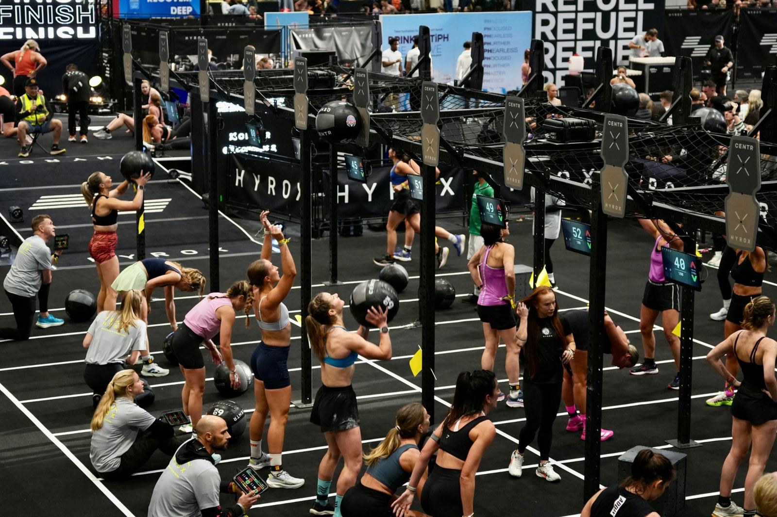 Athletes on the wall ball station at a Hyrox race