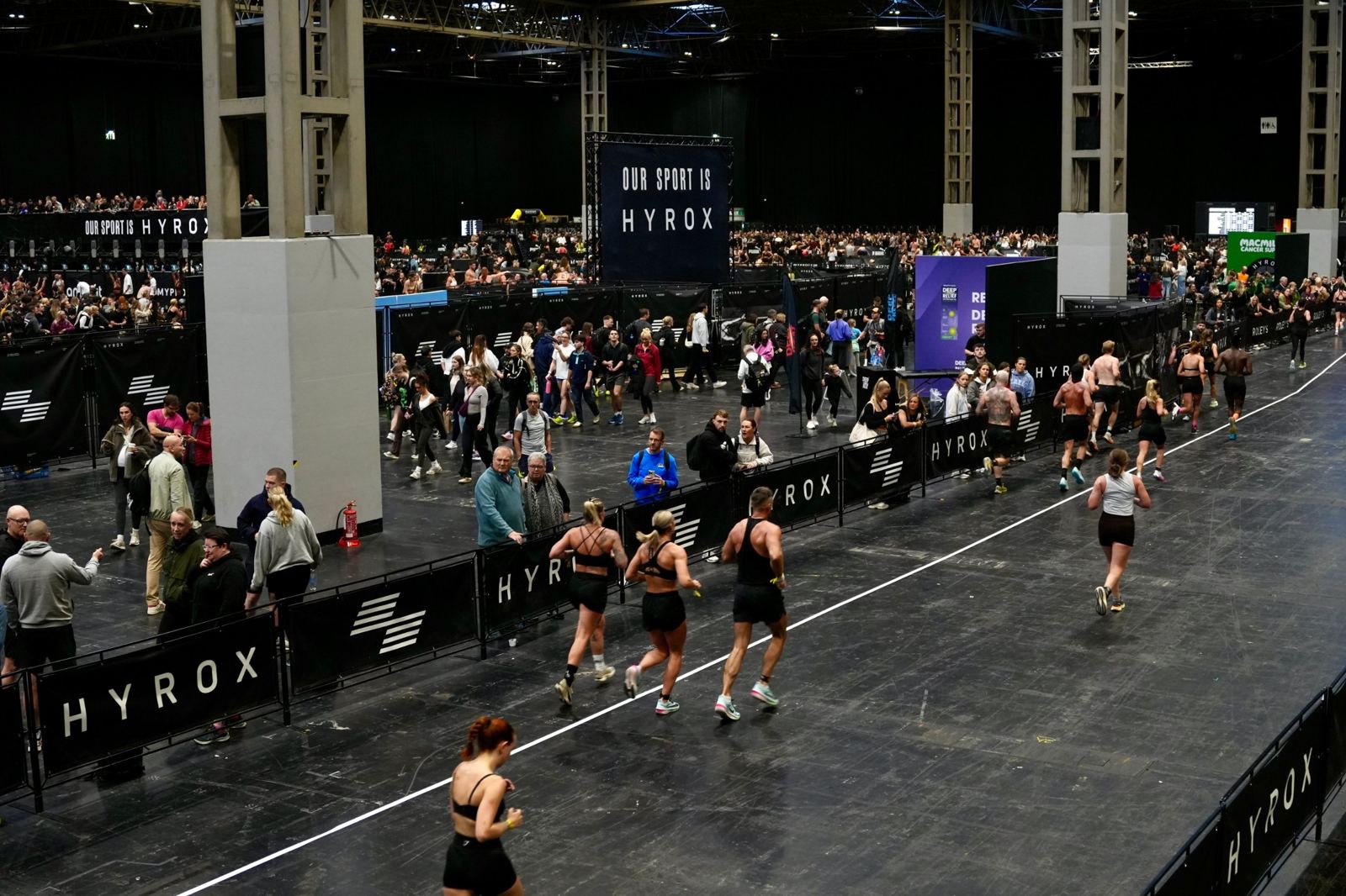 Athletes on a 1 km run lap at a Hyrox race