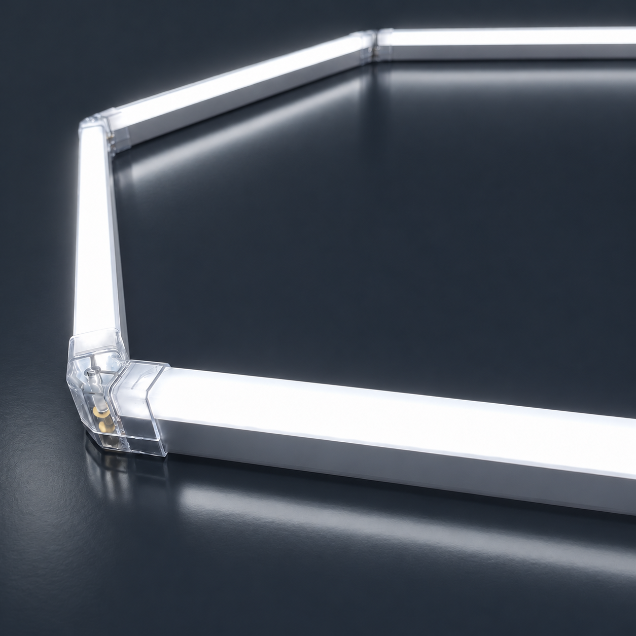 Close-up of a brushed aluminium connector joining two glowing LED tubes