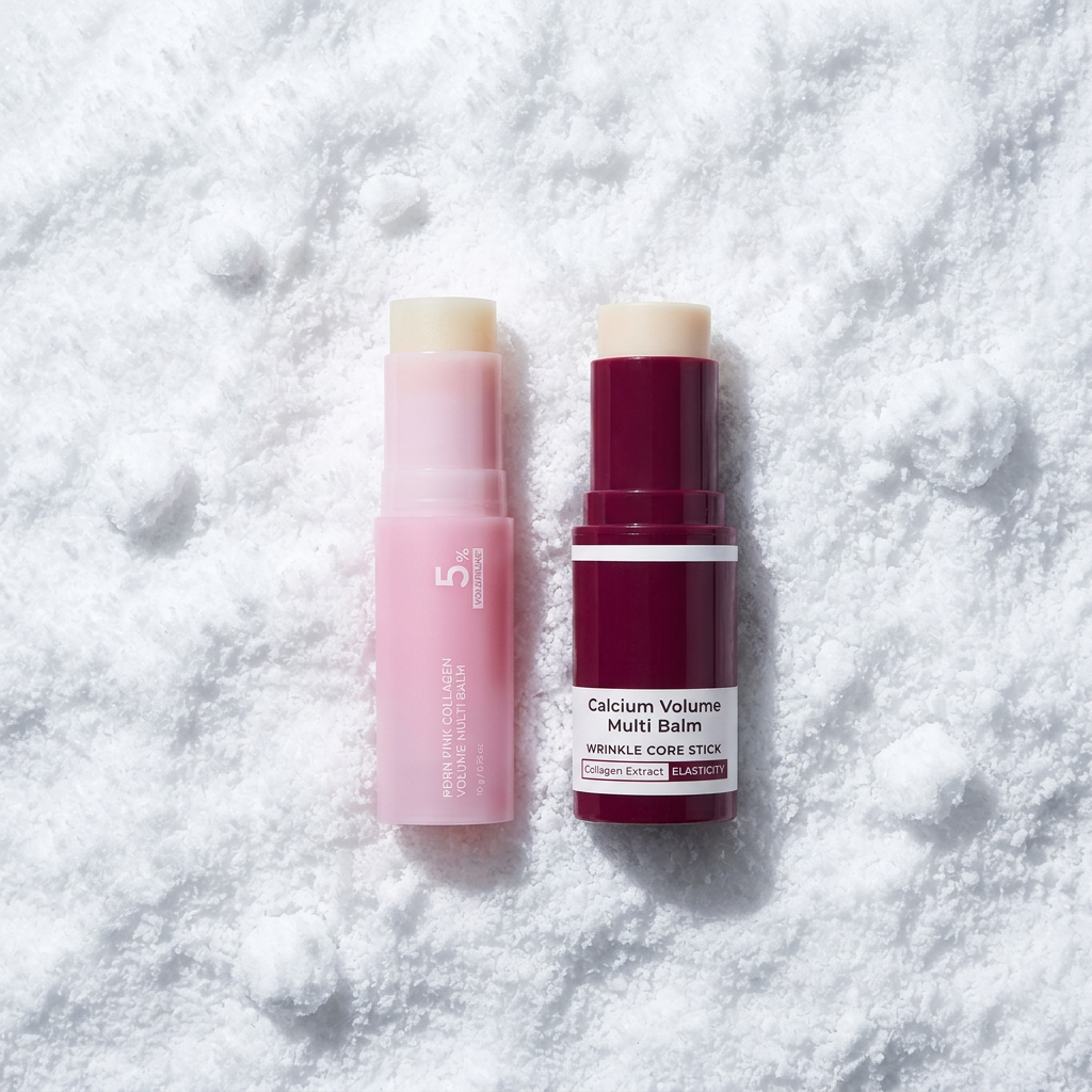 Pink and maroon lip balm sticks on a fluffy, white, snow-like textured surface