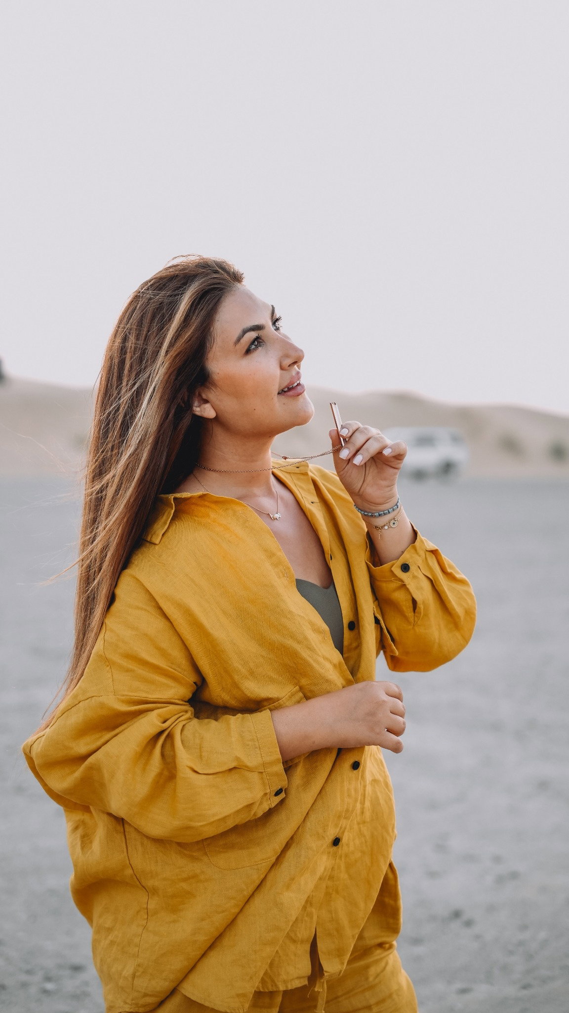 Mais wearing the Nafas breathing necklace in the desert at golden hour