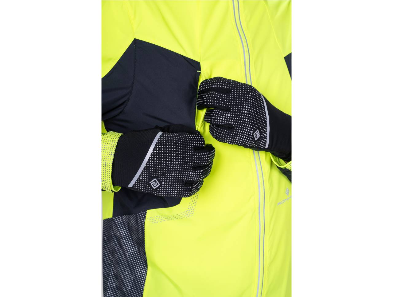 Runner in a fluoro yellow jacket zipping up while wearing black reflective-dot running gloves
