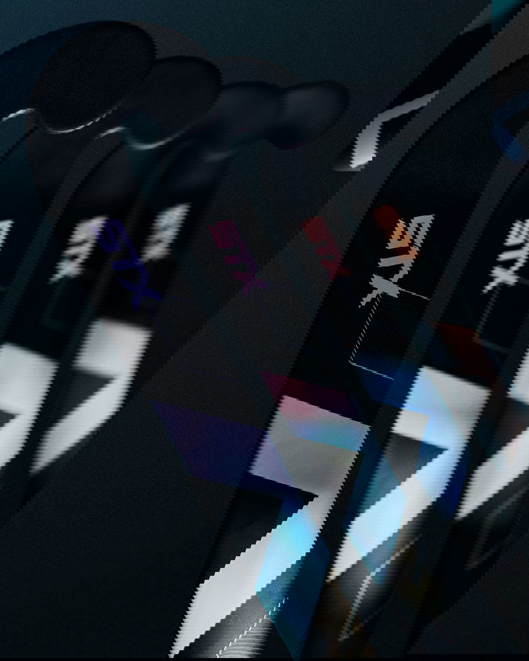 4 field hockey sticks lined up in a row on a black background