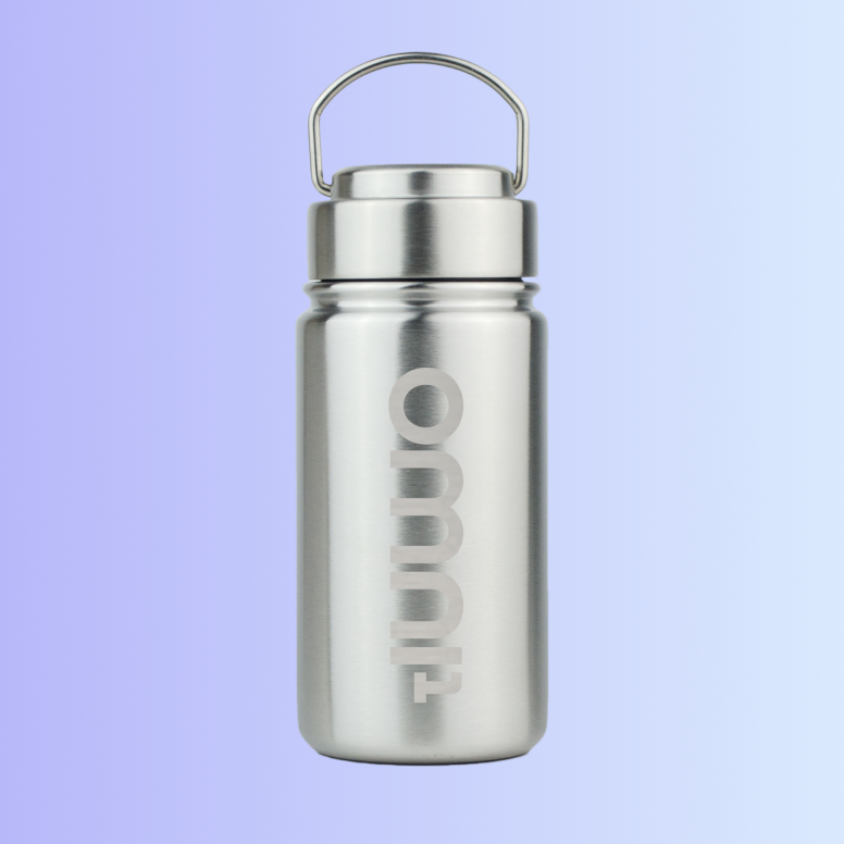 Stainless steel water bottle with a handle lid and branding on the front against a gradient background.