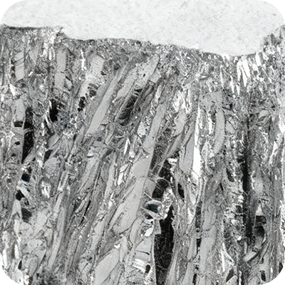 Close-up of a textured metallic surface with layered, jagged patterns.