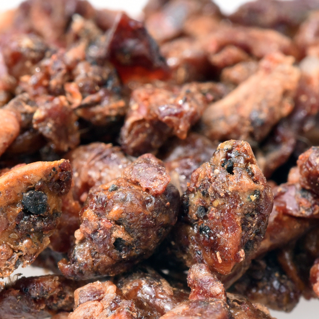 Close-up of dried propolis showing the textured, dark brown surface.