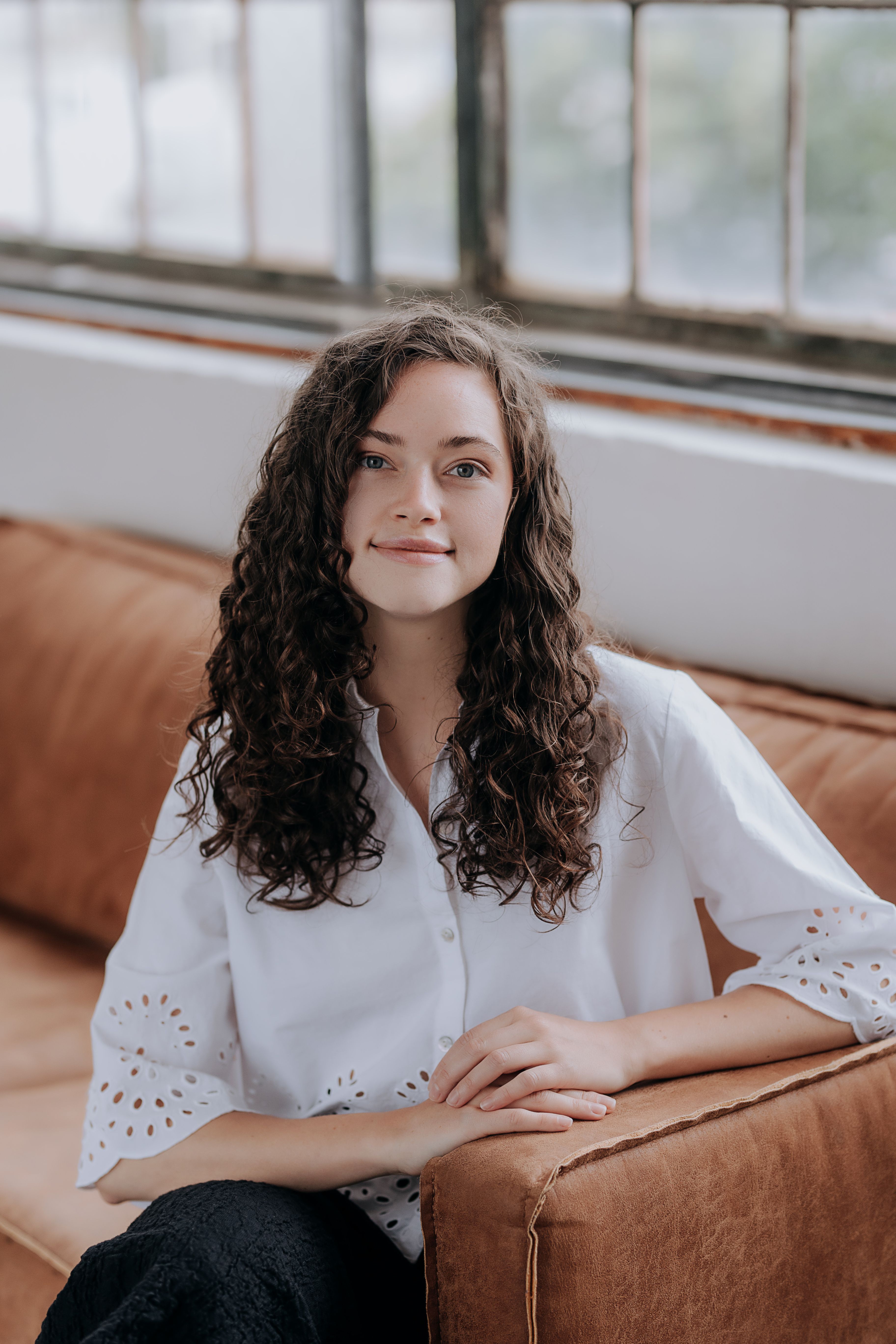 Portrait of Renata Novotna, clinical naturopath at Trime, smiling in a striped blue shirt