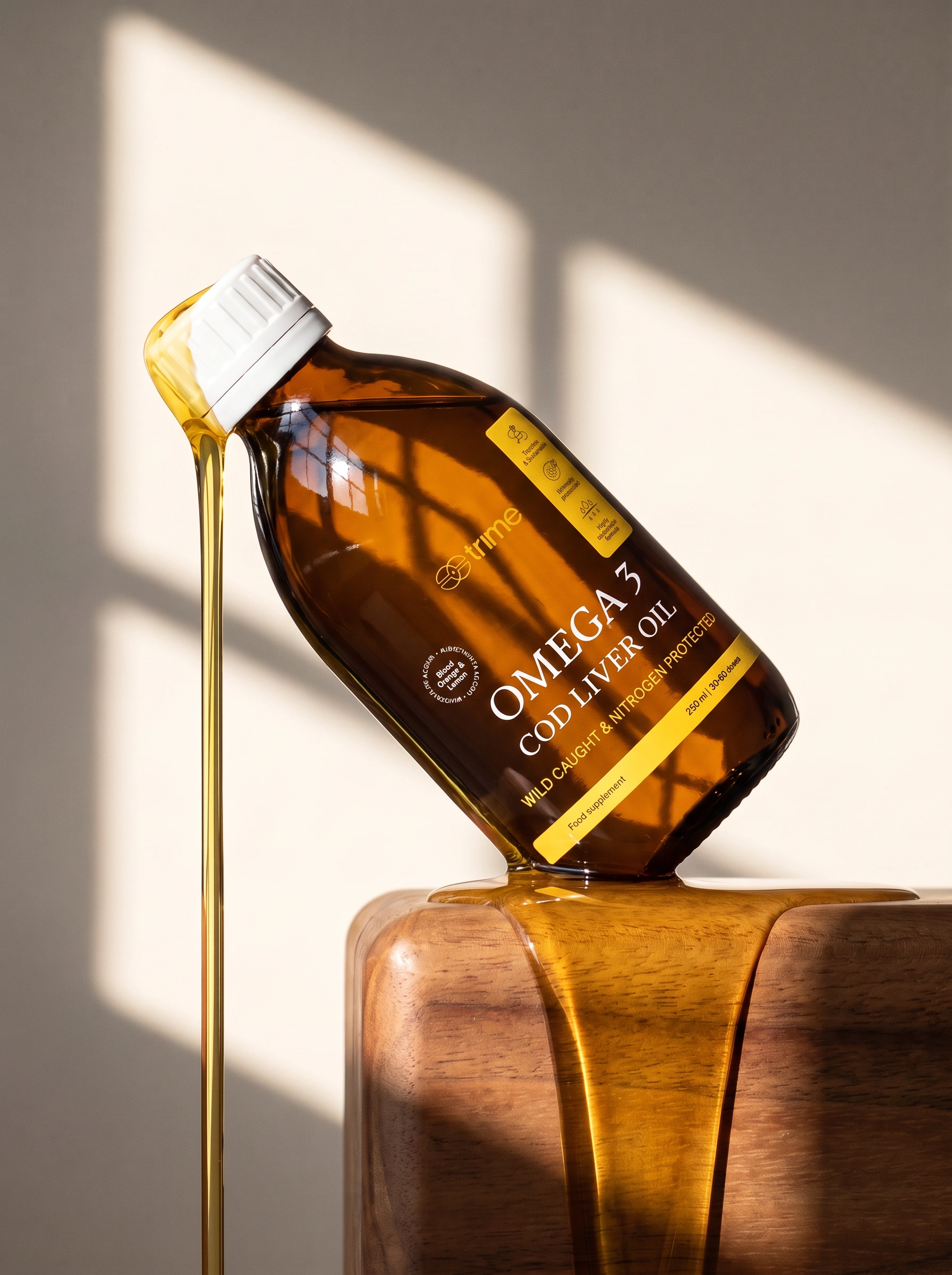 A large omega-3 softgel capsule next to a teaspoon of golden cod liver oil, a blood orange slice and the Trime bottle