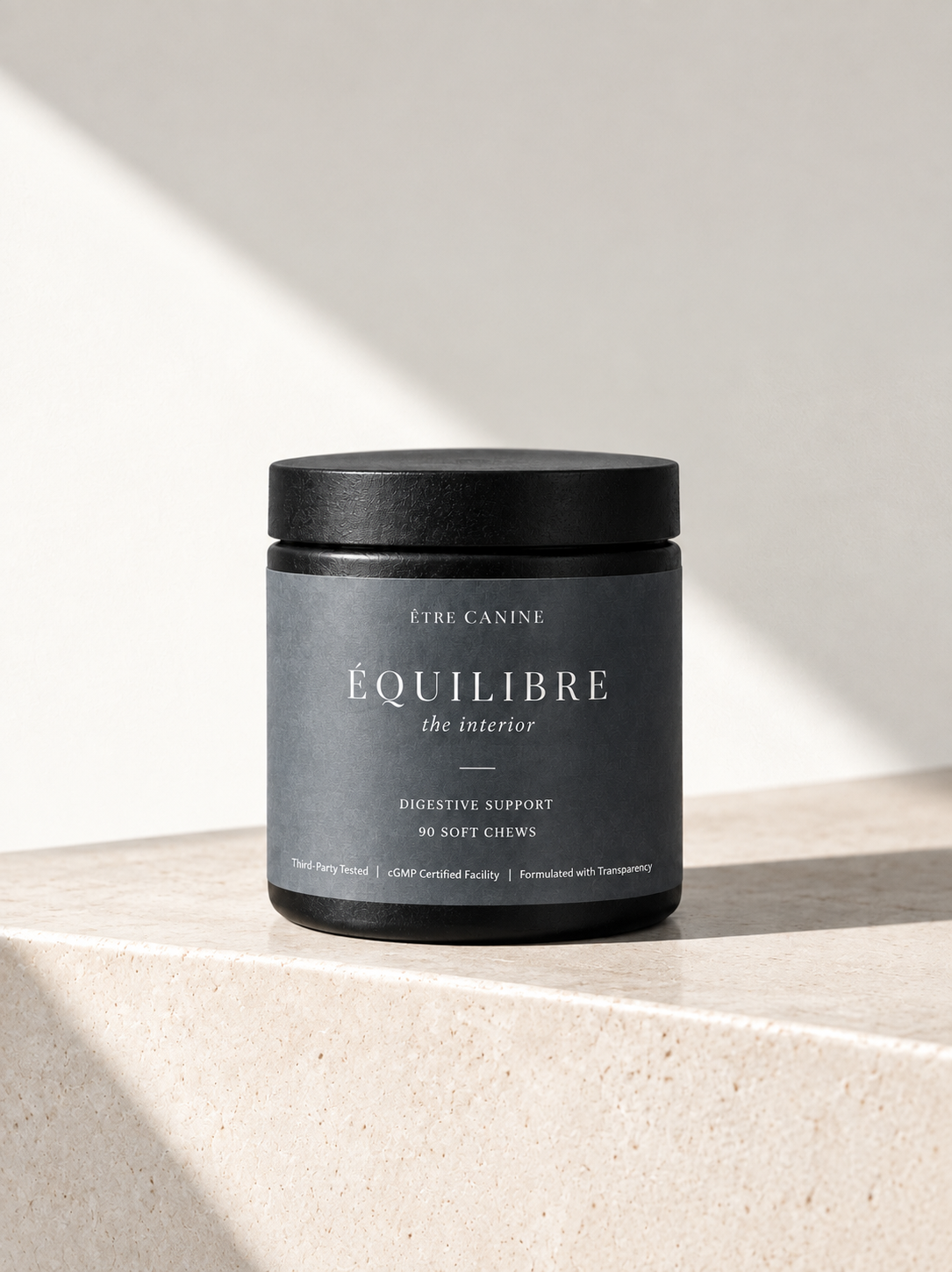 The ÉQUILIBRE jar resting on a travertine ledge in soft daylight