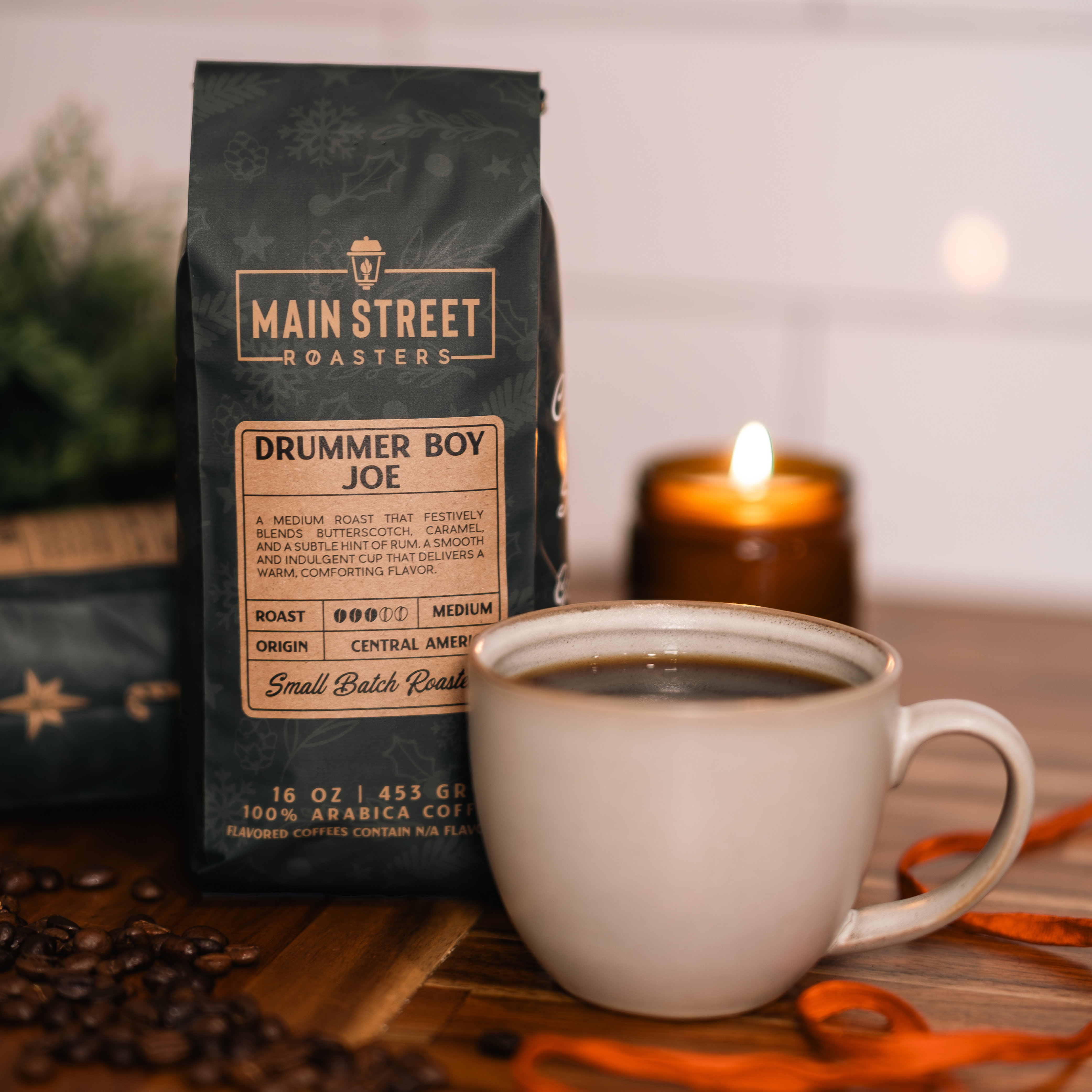 Hands wrapped around a warm cup of Drummer Boy Joe holiday coffee