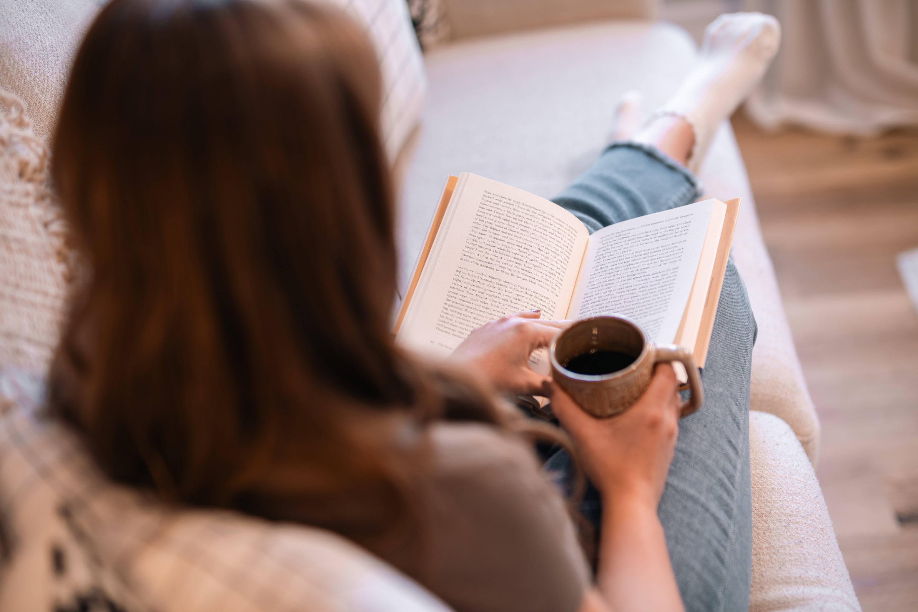 Person holding a fresh mug of coffee