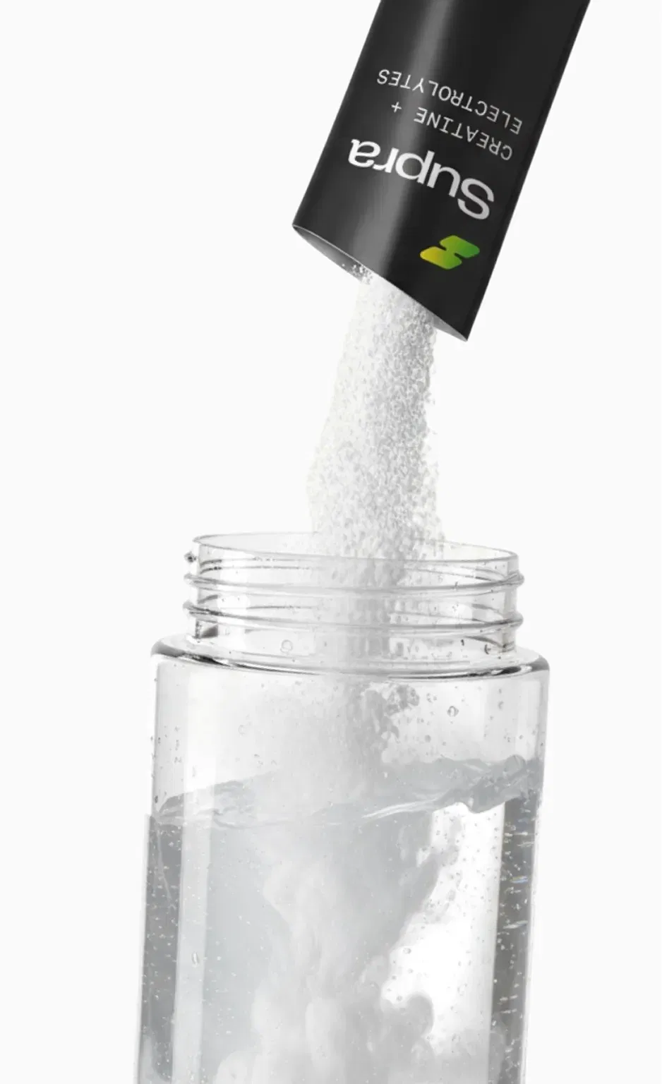 Powder from Supra Creatine and Electrolytes sachet pouring into a clear water bottle.