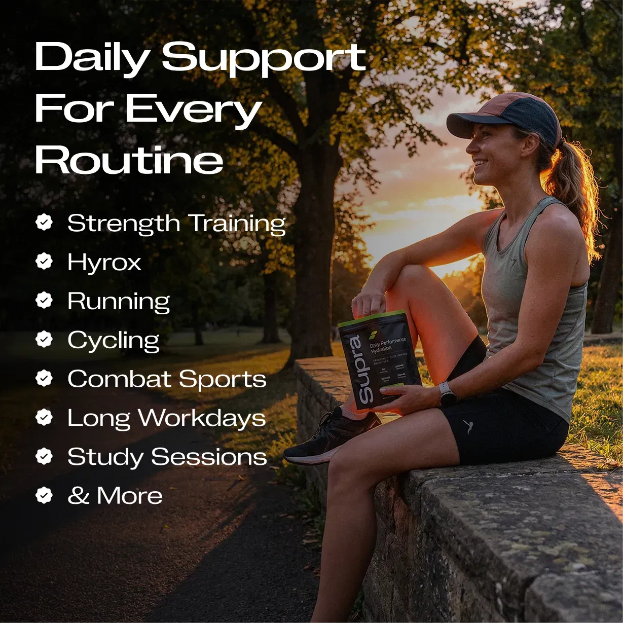 Woman in athletic wear sitting outdoors at sunset holding a Supra hydration pouch.