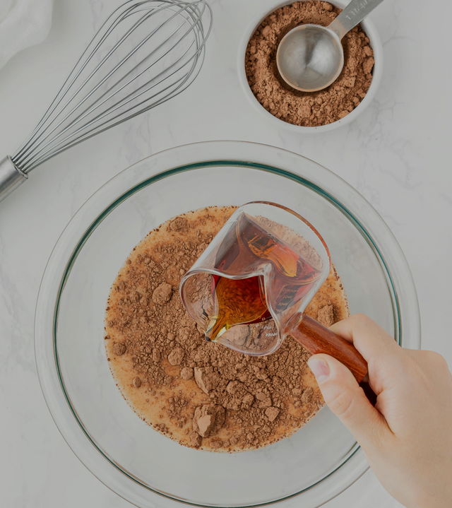 Maple Terroir syrup going into cocoa filled cooking bowl