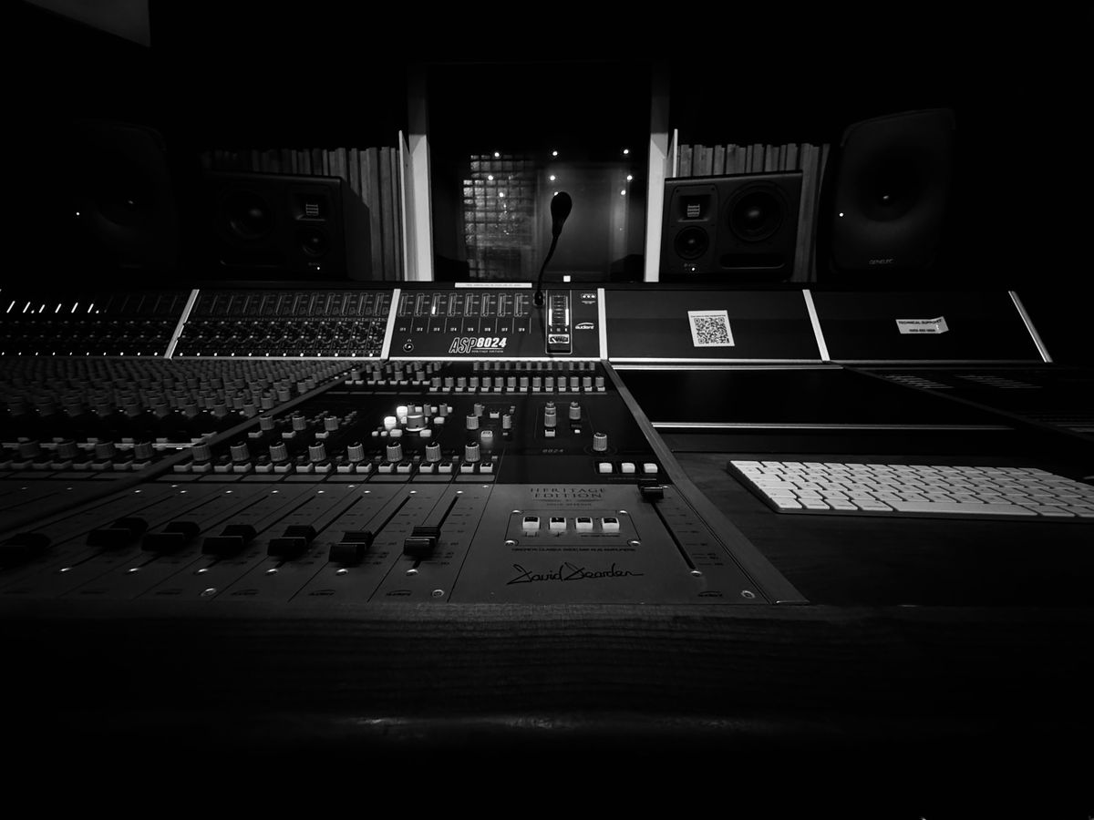 Studio console and microphone in indigo light