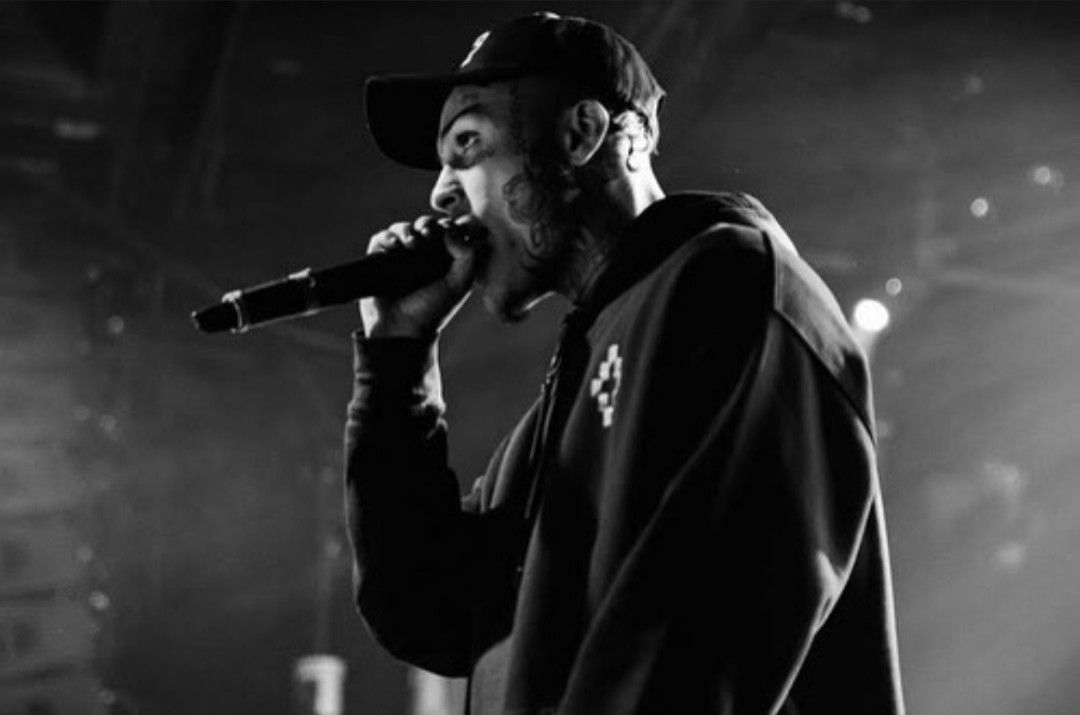Lil Skies performing live in black and white, mic raised under stage lights