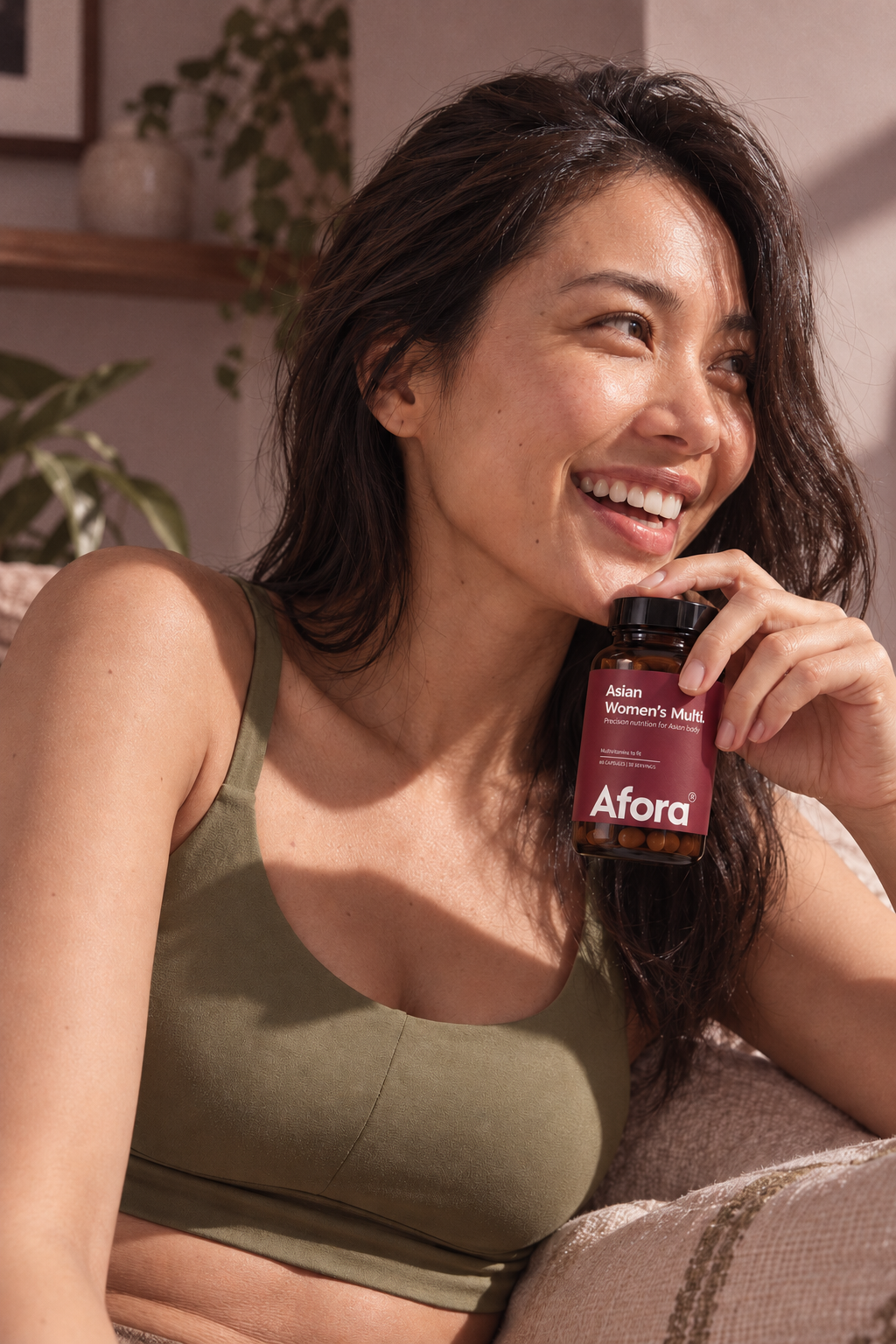 Smiling woman holding her bottle of Afora Asian Women's Multi
