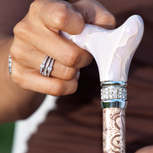woman holding embedded rhinestones cane