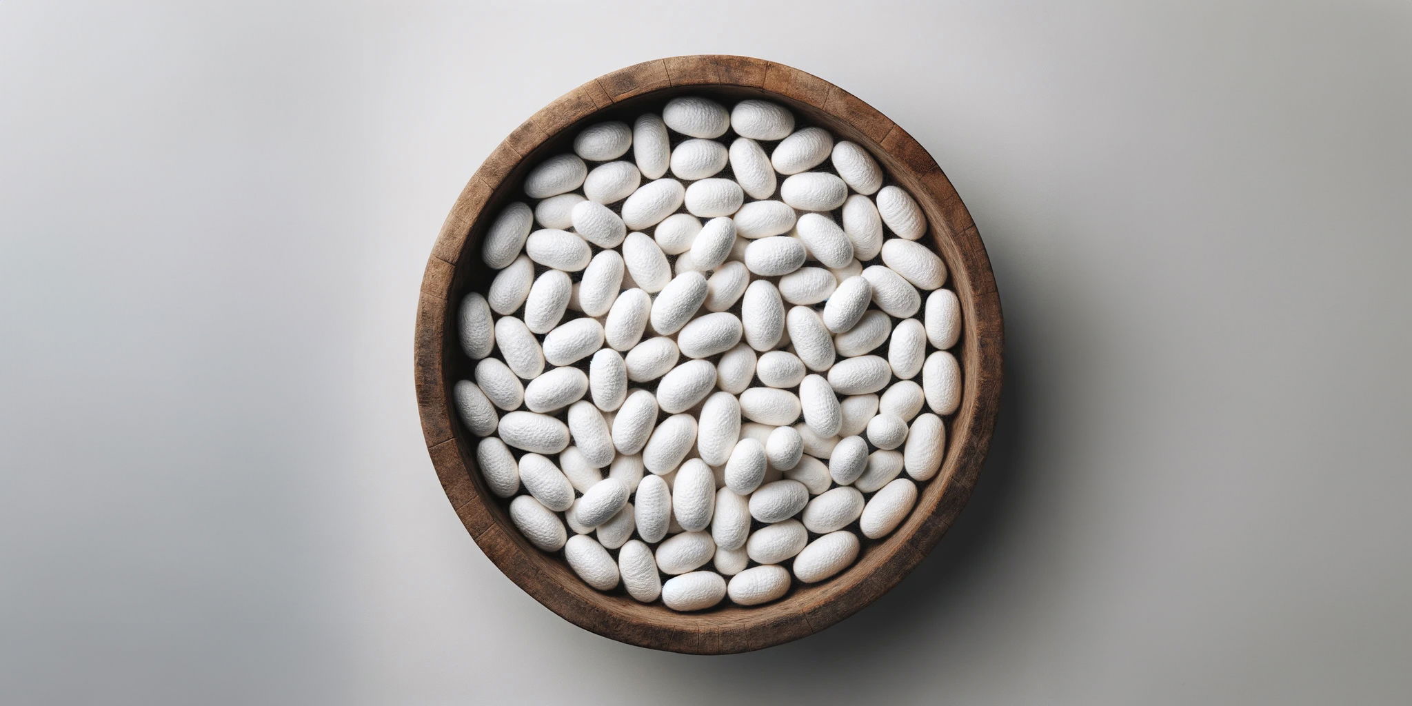 silkworm cocoons in a wooden bowl