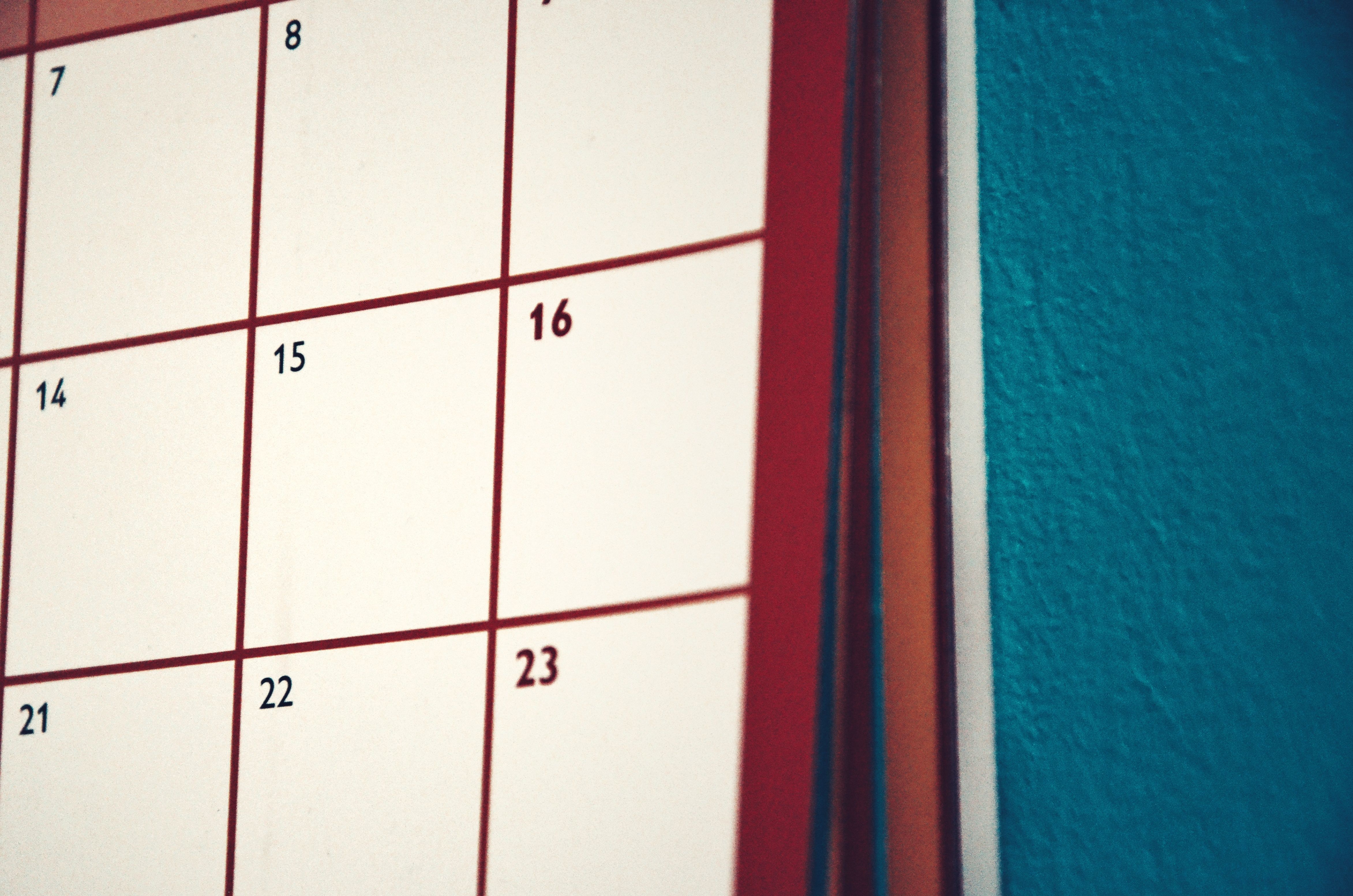 A row of small bottles beside a calendar page and fresh mint