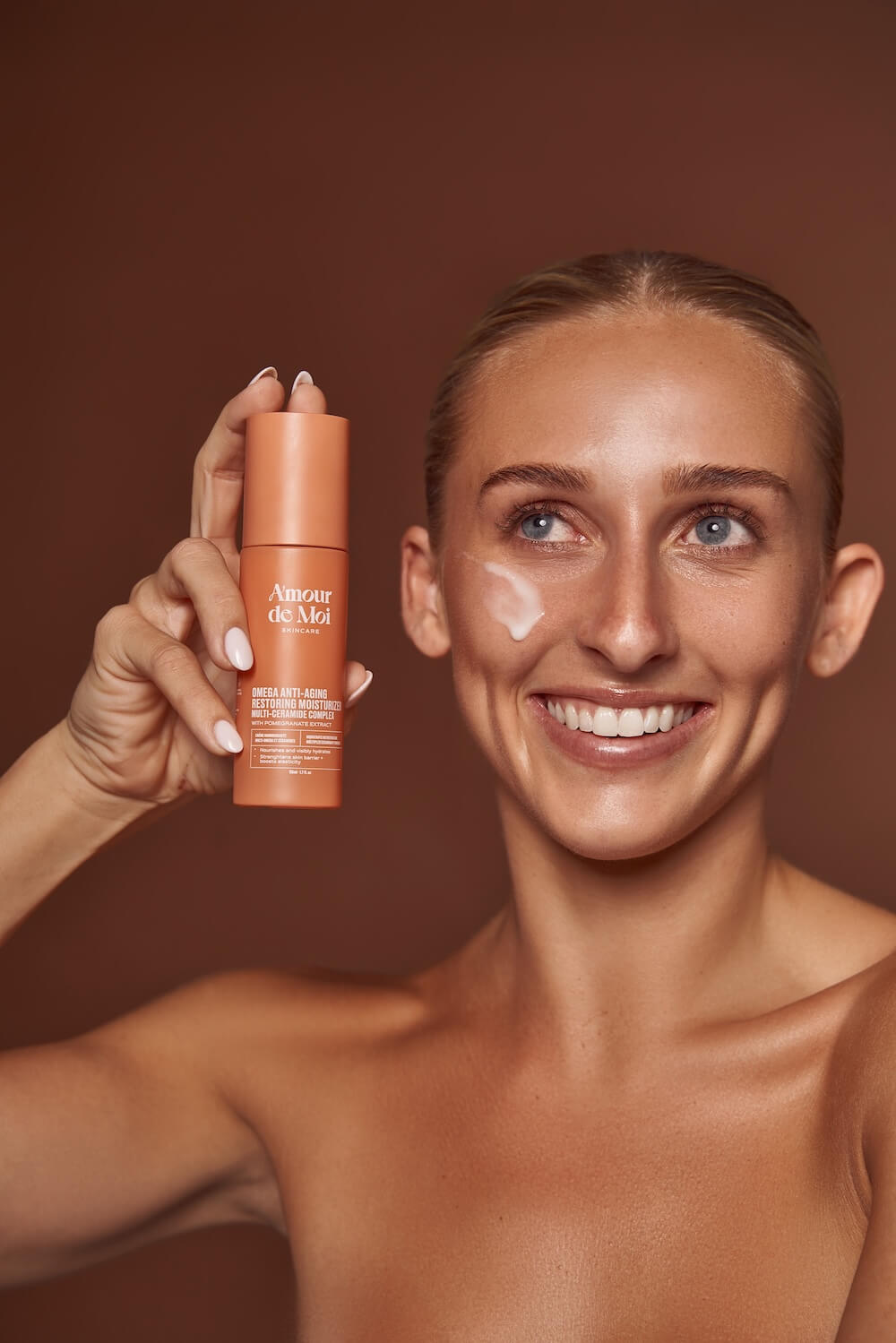 Person applying clear glossy balm to their lips
