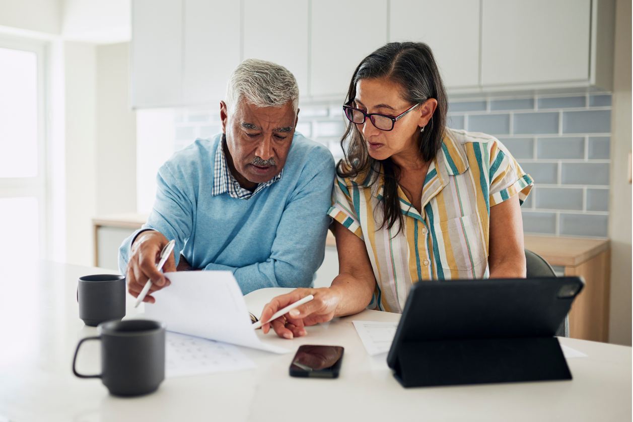 Dementia patient looking at dementia reminder board with adult daughter.