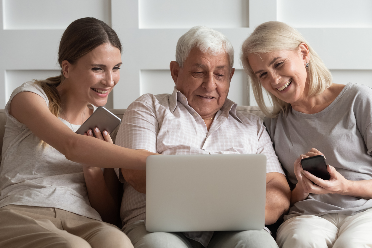 Family with dad with dementia looking at dementia clock device.