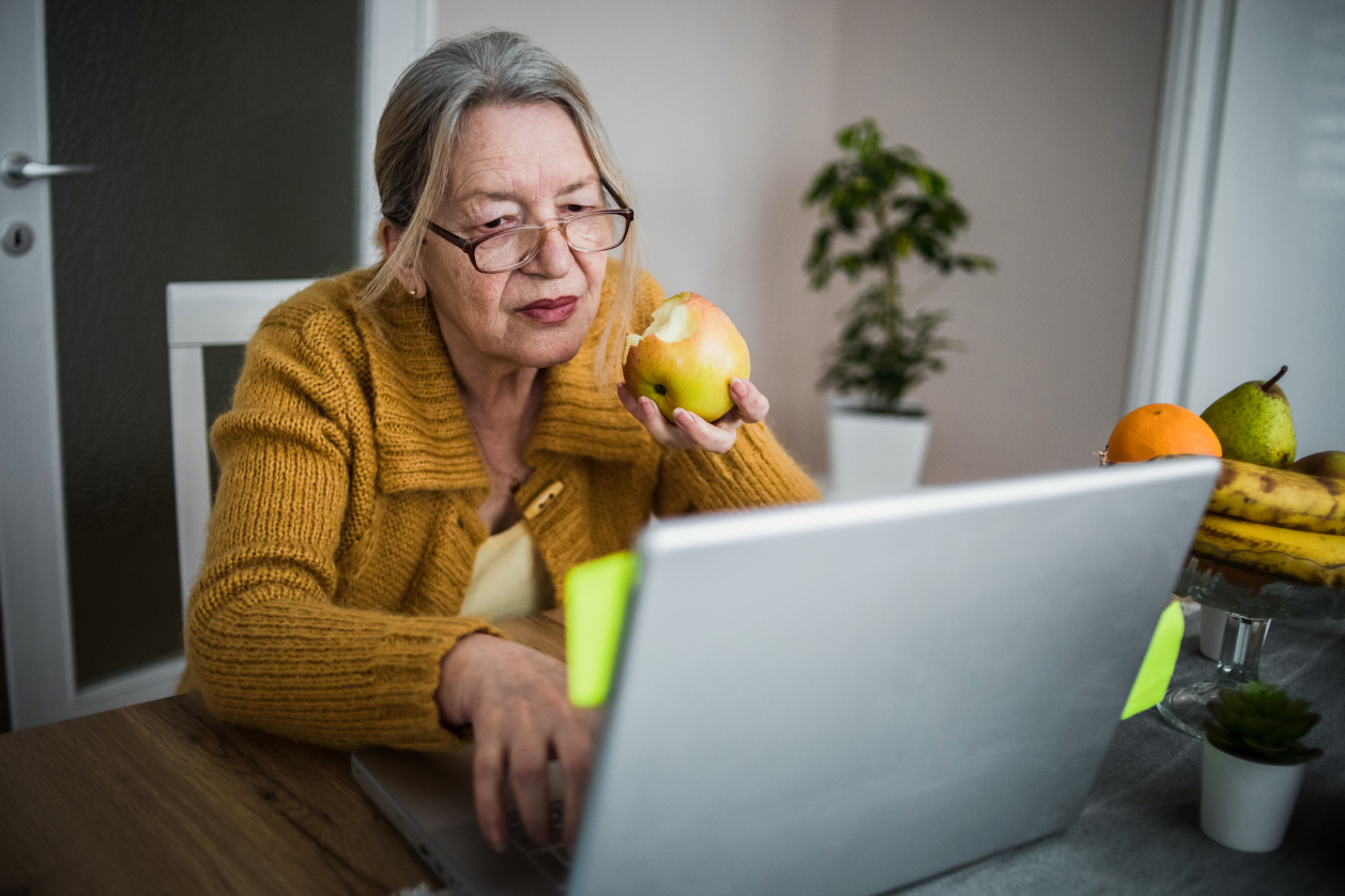 Older adult using apps and devices to support caregiving activities.