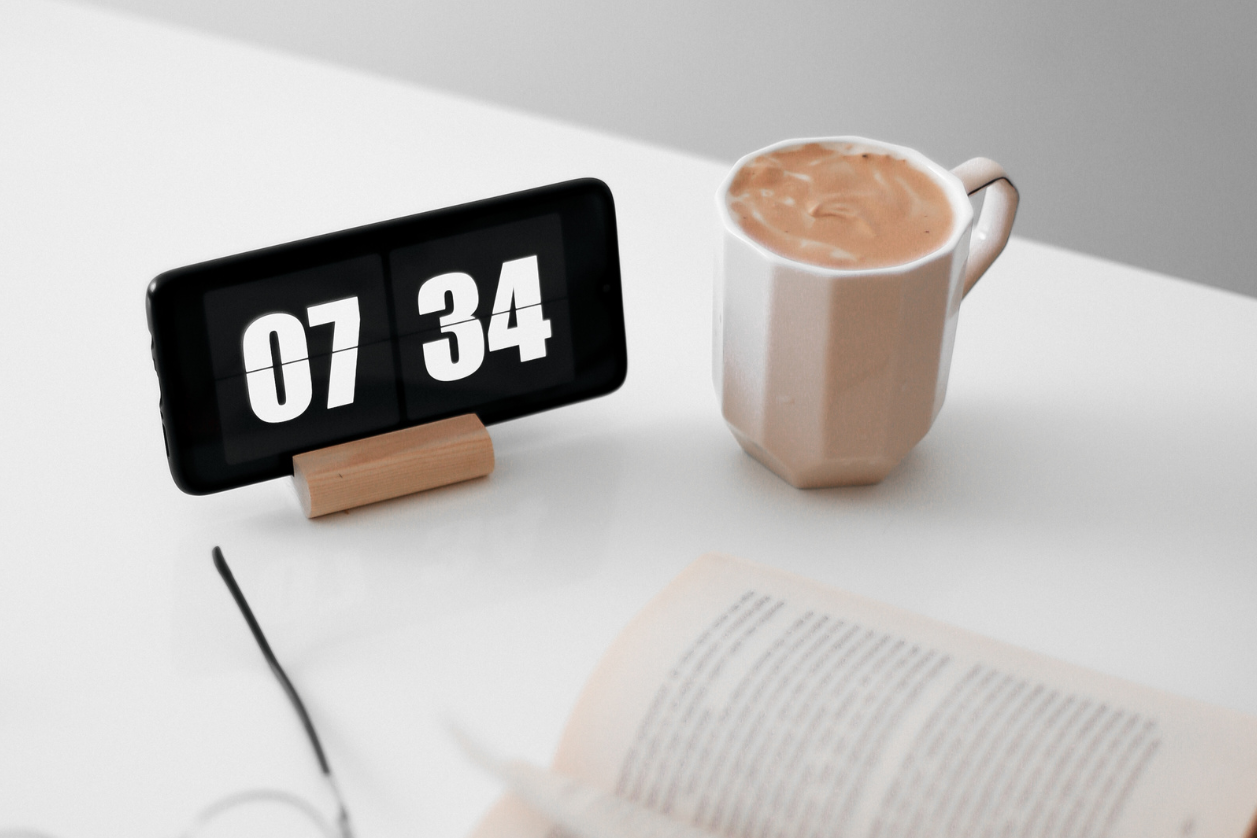 Best dementia clock on a counter next to cup of coffee